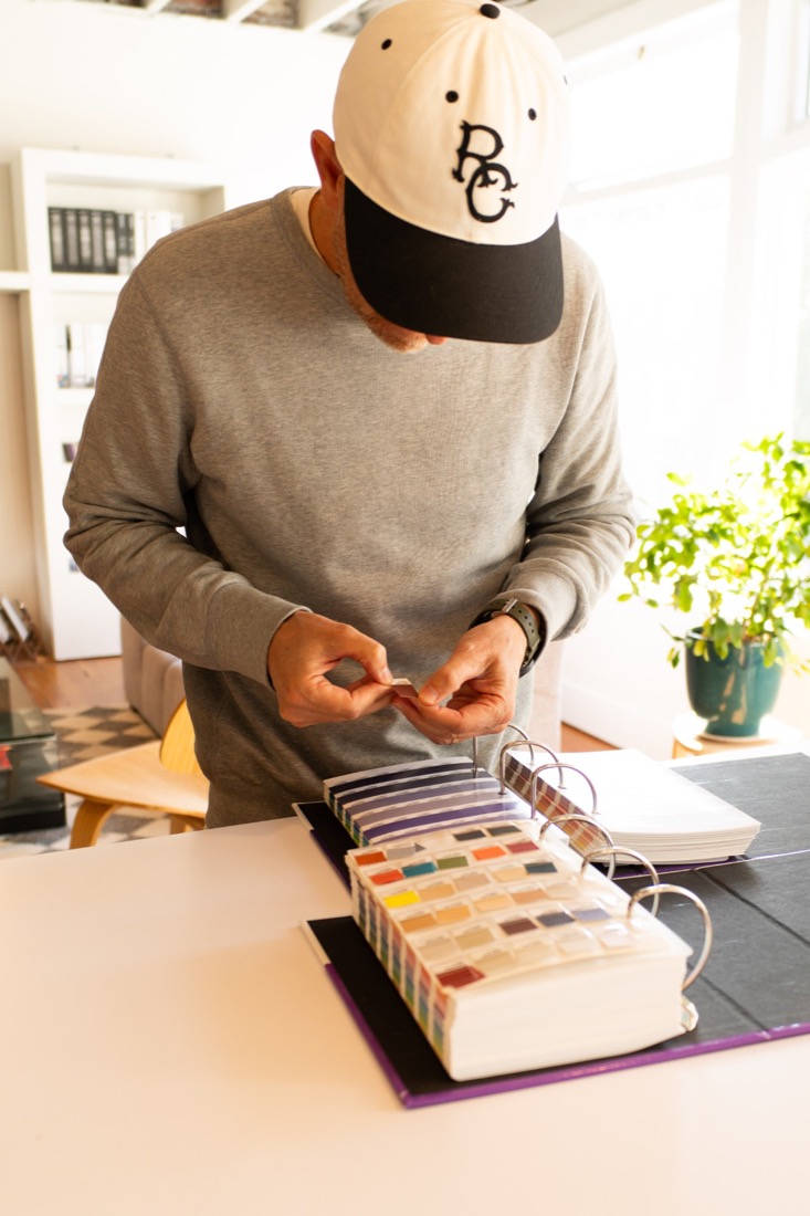 Ross Chandler selecting a colour from a Pantone swatch book at the studio