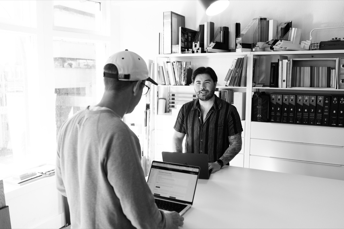 Two of the Becoming team setting up a new client's brand hub